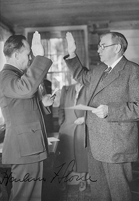 U.S. Commissioner Wayne Hackett (L) swearing in Chief Justice Stone — July 1941 at Sprague’s Lodge, Estes Park, Colorado.